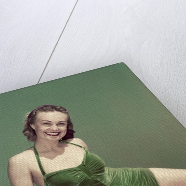 1940s Portrait Smiling Woman Wearing Green Velvet Bathing Suit Sitting Posing On Diving Board by Anonymous