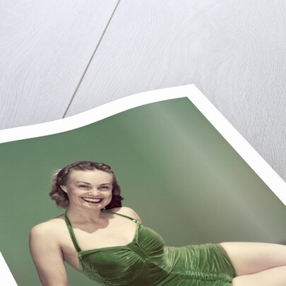 1940s Portrait Smiling Woman Wearing Green Velvet Bathing Suit Sitting Posing On Diving Board by Anonymous