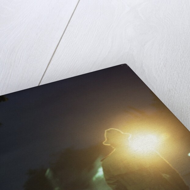 1970s 1980s Anonymous Man Commuter Waiting For Train Silhouetted By Bright Light by Anonymous