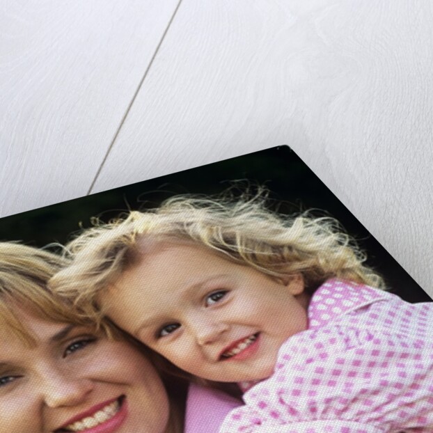 1990s Portrait Of Mother And Daughter Outdoors Looking At Camera Wearing Pink Shirts by Anonymous