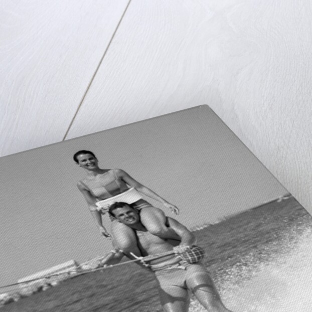 1960s Man Water Skiing With Woman In Bathing Suit Riding On Shoulders by Anonymous