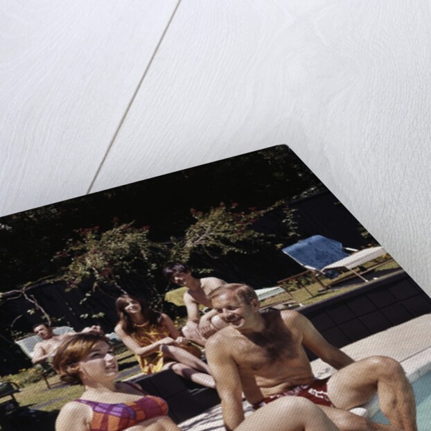 1960s Four People On Patio Couple Man Woman Sitting On Edge Of Swimming Pool by Anonymous