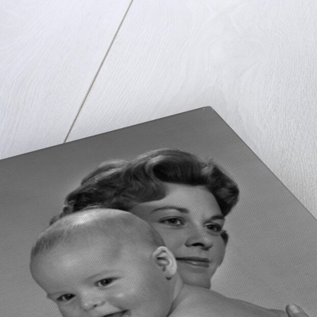 1960s Thoughtful Pensive Mother Holding Happy Baby Child by Anonymous