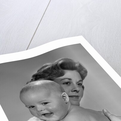 1960s Thoughtful Pensive Mother Holding Happy Baby Child by Anonymous