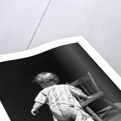 1930s Baby Wearing Drop Seat Pajamas Showing Bare Bottom Leaning On Chair by Anonymous