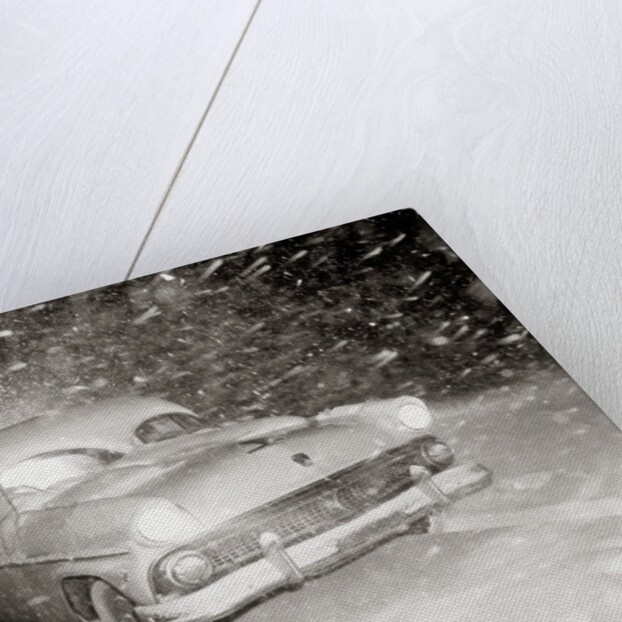 1950s Snow Covered Automobile Driving On Road In Deepening Winter Blizzard Snow by Anonymous
