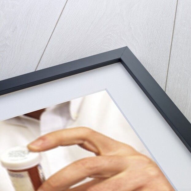 1990s Doctor Writing Refill Prescription For Patient Holding Pill Bottle by Anonymous