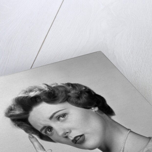1950s Concerned Woman With Reminder String Knot Tied On Finger Of Hand To Help Remember Something Looking At Camera by Anonymous