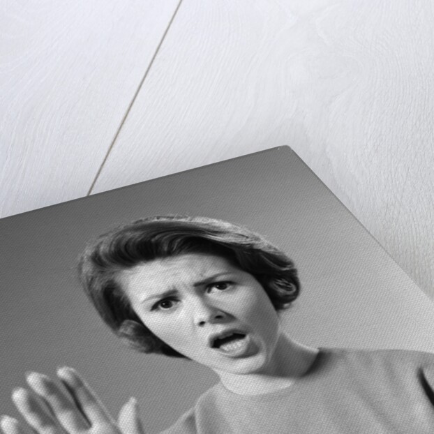 1960s Alarmed Woman Holding Up Her Hand To Stop Something by Anonymous