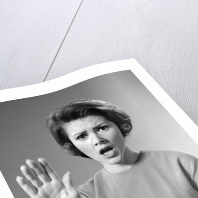 1960s Alarmed Woman Holding Up Her Hand To Stop Something by Anonymous