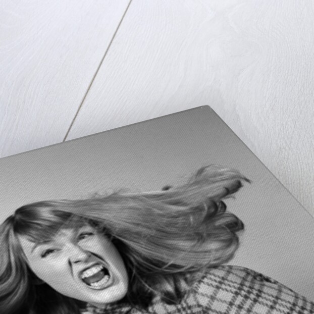 1960s Angry Woman Yelling Gnashing Teeth Hair Flying Looking At Camera by Anonymous