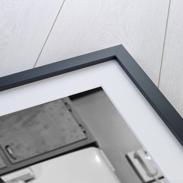 1950s Smiling Woman Housewife Putting Stick Of Butter Into Electric Refrigerator In Kitchen Looking At Camera by Anonymous