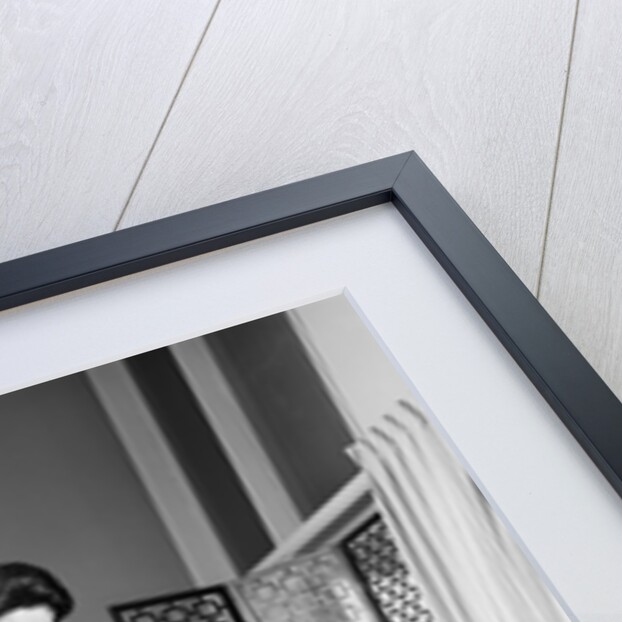 1950s 1960s Woman Wearing A White Blouse & Plaid Skirt Dusting With A Feather Duster A Glass Top Coffee Table by Anonymous