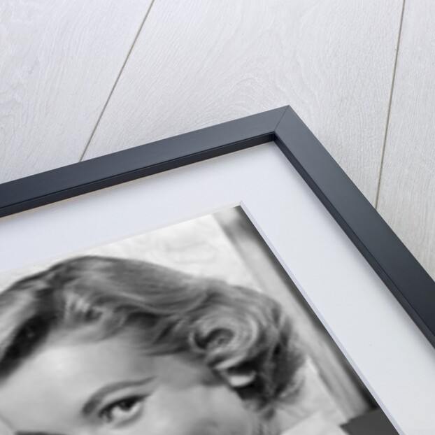 1950s Smiling Blonds Woman Mother Warming A Baby Bottle Of Milk In Kitchen Looking At Camera by Anonymous