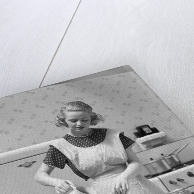 1930s Woman In Kitchen Wearing Apron Making Breakfast Pouring Water Into Coffee Pot by Anonymous