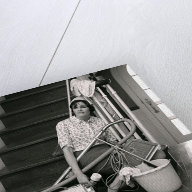1960s 1970s Exhausted Housewife Sitting At Bottom Of Stairs Surrounded By House Cleaning Equipment by Anonymous