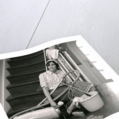 1960s 1970s Exhausted Housewife Sitting At Bottom Of Stairs Surrounded By House Cleaning Equipment by Anonymous