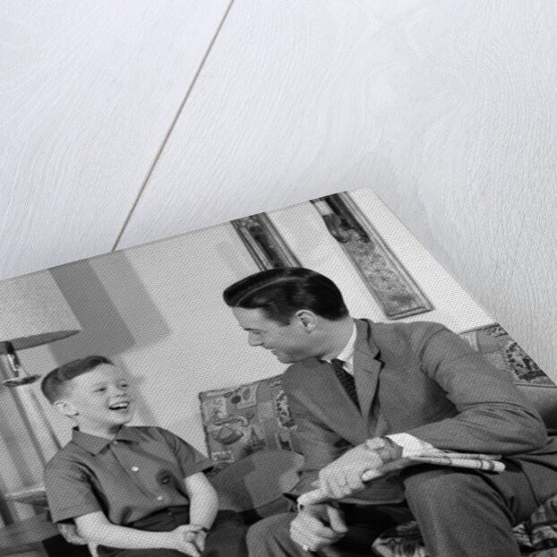 1960s Boy Sitting On Couch Smiling Laughing Talking With Dad by Anonymous