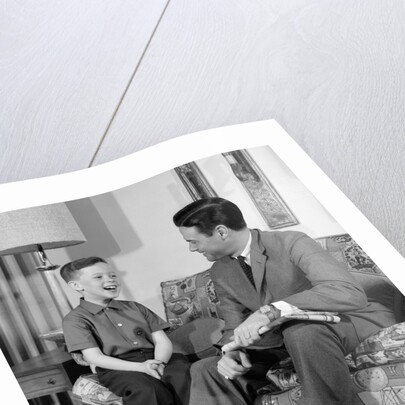 1960s Boy Sitting On Couch Smiling Laughing Talking With Dad by Anonymous