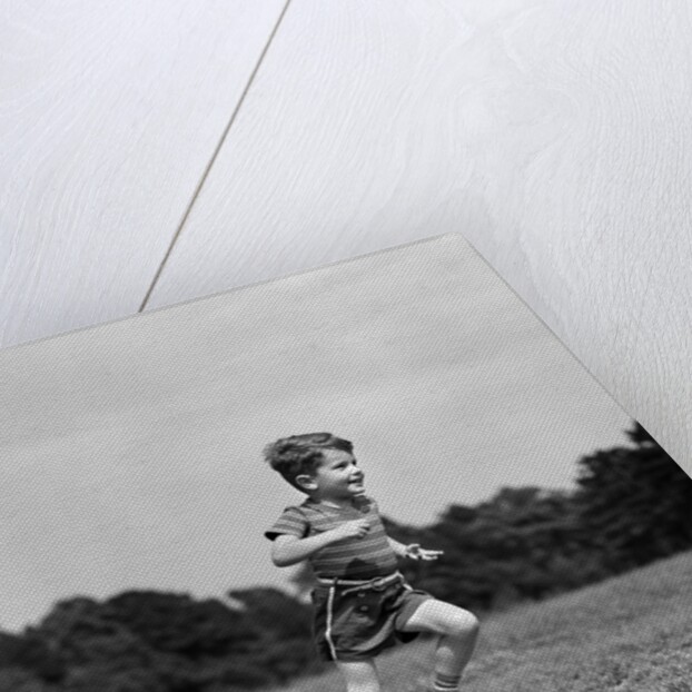 1940s Little Boy Running Playing On Grassy Field by Anonymous