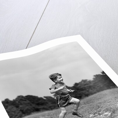 1940s Little Boy Running Playing On Grassy Field by Anonymous
