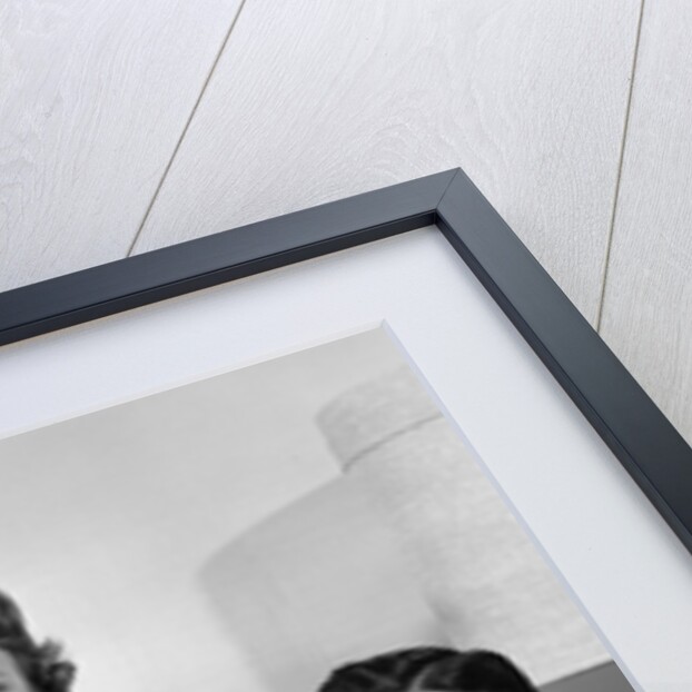 1960s Family Sitting On Couch Smiling Looking At Camera by Anonymous