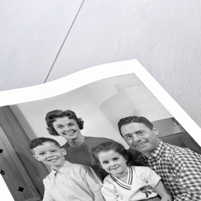 1960s Family Sitting On Couch Smiling Looking At Camera by Anonymous