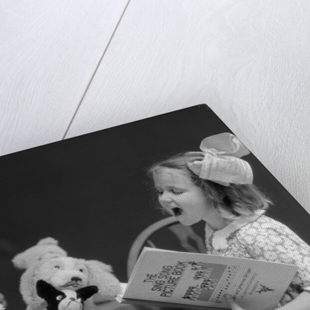 1930s Enthusiastic Little Girl Big Bow Ribbon In Her Hair Singing To Assembled Group Of Dolls Toys And Stuffed Animals by Anonymous