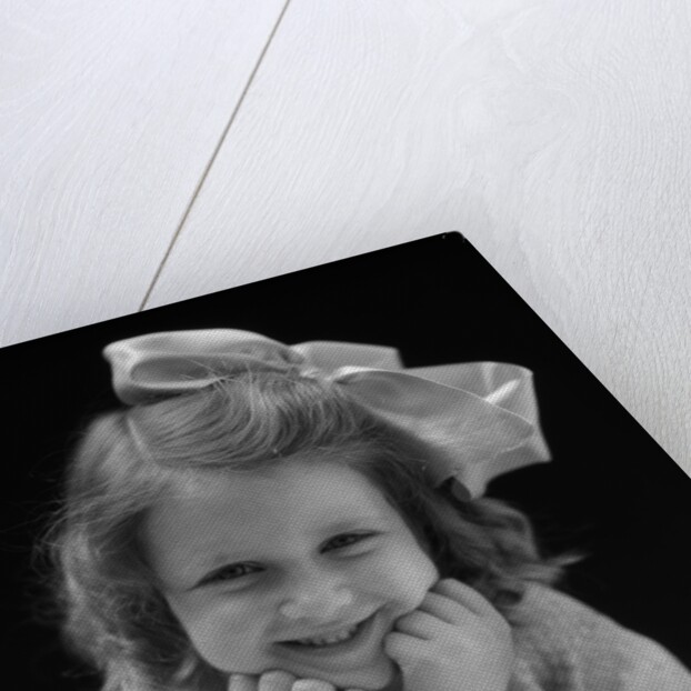 1930s Portrait Smiling Brunette Girl With Big Ribbon Bow In Her Hair Looking At Camera by Anonymous