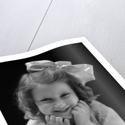 1930s Portrait Smiling Brunette Girl With Big Ribbon Bow In Her Hair Looking At Camera by Anonymous