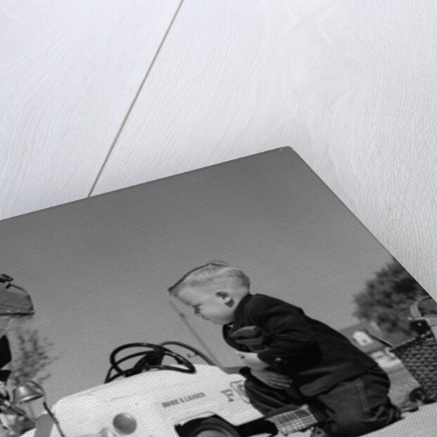 1950s Boy And Girl Playing At Repairing Toy Car by Anonymous