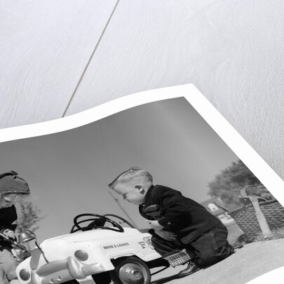 1950s Boy And Girl Playing At Repairing Toy Car by Anonymous