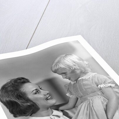 1960s Mother Holding Little Blond Girl Wearing Fancy Dress In Her Arms Looking At Each Other by Anonymous