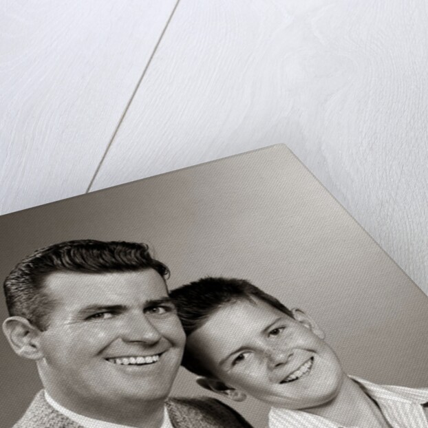 1950s Studio Portrait Smiling Man Father And Boy Son Sitting Together Looking At Camera by Anonymous
