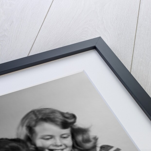 1950s Portrait Mother Two Daughters And Son Reading Book Together by Anonymous