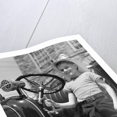 1930s Smiling Boy Standing Next To Fire Engine Wearing Firemans Hat by Anonymous