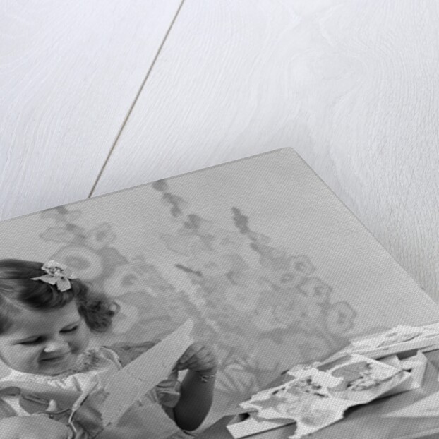 1940s Smiling Little Girl Cutting Paper With Scissors by Anonymous