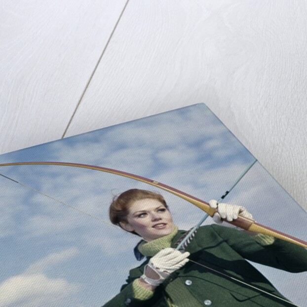 1960s 1970s Sports Woman Archer Holding Bow Preparing To Draw Arrow by Anonymous