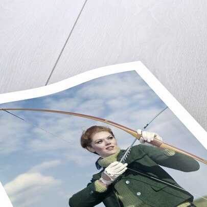 1960s 1970s Sports Woman Archer Holding Bow Preparing To Draw Arrow by Anonymous