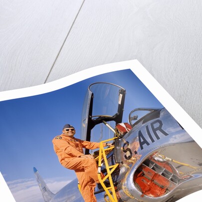 1960s 1970s Smiling Military Pilot Ladder Climbing Enter Cockpit Looking At Camera by Anonymous