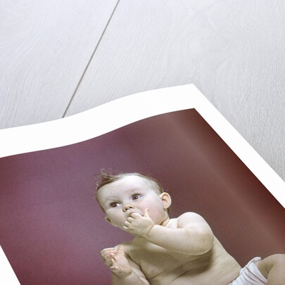 1940s 1950s Baby Diaper Sitting Looking Up Fingers In Mouth by Anonymous