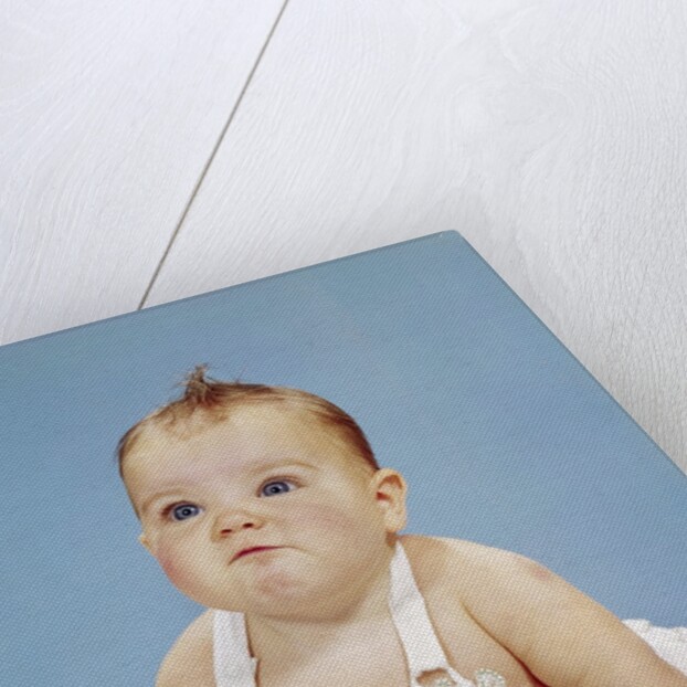 1960s Baby Making Funny Face Pushed Up On Arms Crawling Forward by Anonymous