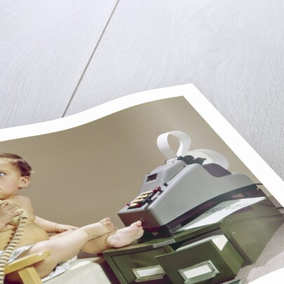 1960s Business Baby Sitting In Chair Holding Telephone With Calculator Adding Machine File Drawers Looking Back Over Shoulder by Anonymous