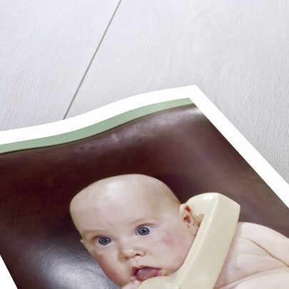 1960s Chubby Baby Sitting In Leather Office Chair Talking On Telephone by Anonymous