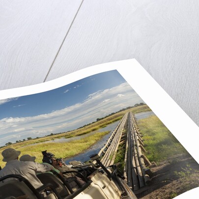 Safari Vehicle Crossing Bridge by Anonymous