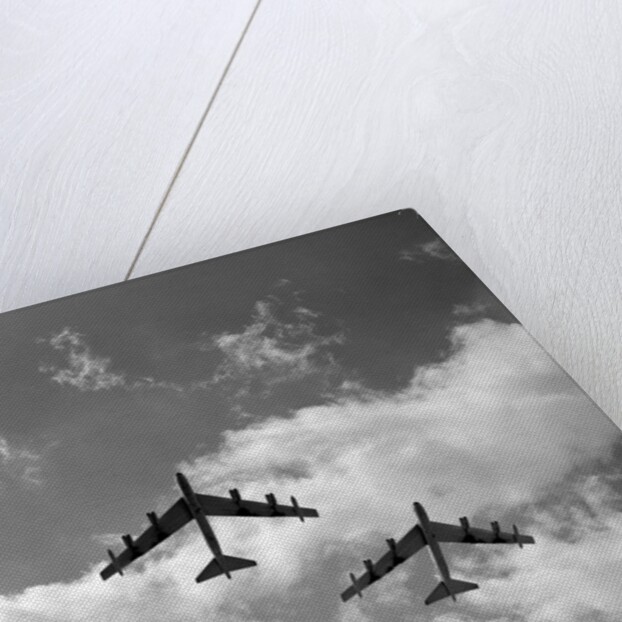 1950s three B-52 bomber airplanes in flight formation by Anonymous