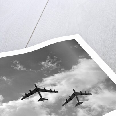 1950s three B-52 bomber airplanes in flight formation by Anonymous