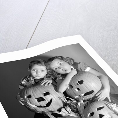 1950s boy and girl with four jack-o-lanterns by Anonymous
