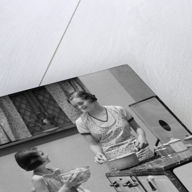 1920s young girl helping her mother to cook by Anonymous