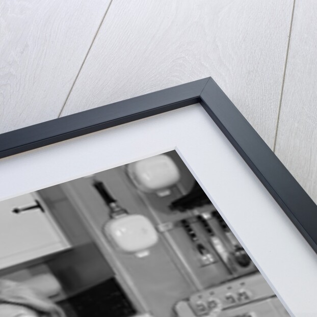1960s smiling housewife sitting on full laundry basket by Anonymous